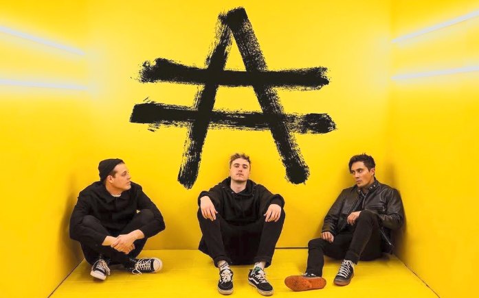 Adam's Number, the three of them sitting under the band's mark in a yellow room